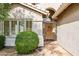 Close-up of the home's entryway with a wooden front door, well-manicured landscaping, and a stucco exterior at 17828 N 50Th St, Scottsdale, AZ 85254