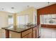 Kitchen island with a granite countertop, stainless steel sink, and modern cabinetry, tile flooring, bright windows at 17828 N 50Th St, Scottsdale, AZ 85254