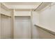 Spacious walk-in closet with ample shelving and metal hanging rods for organized storage at 17828 N 50Th St, Scottsdale, AZ 85254