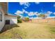 Expansive backyard showing a well-maintained lawn, block fence, and the home's exterior with visible AC unit at 1840 E Jarvis Ave, Mesa, AZ 85204