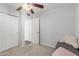 A modest bedroom featuring a ceiling fan, closet, and neutral-toned decor at 1840 E Jarvis Ave, Mesa, AZ 85204