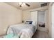 Well-lit bedroom with a ceiling fan, and a closet with a sliding door at 1840 E Jarvis Ave, Mesa, AZ 85204