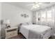 Bright bedroom featuring a comfortable bed, ceiling fan, and two windows with natural light at 1840 E Jarvis Ave, Mesa, AZ 85204