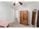 A simple bedroom with a ceiling fan, closet, and neutral-toned decor at 1840 E Jarvis Ave, Mesa, AZ 85204