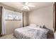 Comfortable bedroom featuring a ceiling fan, a large window, and neutral tones at 1840 E Jarvis Ave, Mesa, AZ 85204