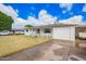 Charming single-story home featuring a welcoming porch, a well-maintained lawn, and an attached garage with an open carport at 1840 E Jarvis Ave, Mesa, AZ 85204