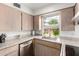 Updated kitchen featuring stainless appliances, a large window, and granite countertops at 1840 E Jarvis Ave, Mesa, AZ 85204