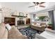 Warm living room with a stone fireplace, built-in bookshelves, comfortable seating, and a decorative rug at 1840 E Jarvis Ave, Mesa, AZ 85204