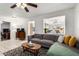 Comfortable living room featuring tile floors, recessed lighting, and a view into the dining area at 1840 E Jarvis Ave, Mesa, AZ 85204