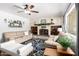 Warm living room with a stone fireplace, built-in bookshelves, comfortable seating, and a decorative rug at 1840 E Jarvis Ave, Mesa, AZ 85204