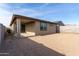 Home's backyard featuring a covered patio, window, block fence, and ample space for outdoor enjoyment at 1971 S 241St Dr, Buckeye, AZ 85326