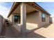 Covered back patio with a view of the sliding glass door and backyard, perfect for outdoor entertaining at 1971 S 241St Dr, Buckeye, AZ 85326