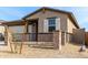 Beautiful single-story house showcasing a well-maintained front yard with decorative stone accents at 1971 S 241St Dr, Buckeye, AZ 85326