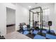 The weight room connects directly to an additional bedroom and is brightly lit with workout equipment at 1971 S 241St Dr, Buckeye, AZ 85326