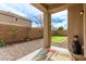 Backyard patio featuring rock landscaping and a small artificial turf area at 21145 E Via De Olivos --, Queen Creek, AZ 85142