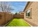 A private backyard with artificial grass and block wall, offers a low-maintenance outdoor space at 21145 E Via De Olivos --, Queen Creek, AZ 85142