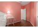 Cozy pink bedroom features wood floors, a table, and a lamp at 21145 E Via De Olivos --, Queen Creek, AZ 85142