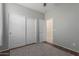 Neutral bedroom featuring wood floors, a gray rug, and a closet with sliding doors at 21145 E Via De Olivos --, Queen Creek, AZ 85142