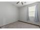 Neutral-toned bedroom with wood floors, a window with curtains, and a modern ceiling fan at 21145 E Via De Olivos --, Queen Creek, AZ 85142