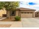 Charming single-story home featuring a two-car garage, desert landscaping, and a tile roof at 21145 E Via De Olivos --, Queen Creek, AZ 85142