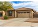 Front view of a lovely home featuring a two-car garage, desert landscaping, and tiled roof at 21145 E Via De Olivos --, Queen Creek, AZ 85142