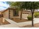 Side view of the home showcasing the desert landscaping, window shutters, and walkway at 21145 E Via De Olivos --, Queen Creek, AZ 85142