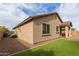 View of a house's exterior with green artificial grass and rock groundcover surrounding the perimeter at 21145 E Via De Olivos --, Queen Creek, AZ 85142