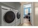 Laundry room with washer and dryer units, and a view into a blue bedroom at 21145 E Via De Olivos --, Queen Creek, AZ 85142