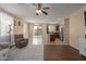 Open-concept living room featuring tile and wood floors, ceiling fan, and sliding glass doors to the backyard at 21145 E Via De Olivos --, Queen Creek, AZ 85142