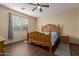 Main bedroom features wood floors, a large window, and a wood bed frame at 21145 E Via De Olivos --, Queen Creek, AZ 85142