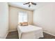 Modest bedroom featuring a ceiling fan, wood flooring, and a window at 2185 N Beverly Pl, Buckeye, AZ 85396