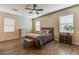 Bedroom featuring wood floors, neutral paint, three windows, and ceiling fan at 2185 N Beverly Pl, Buckeye, AZ 85396