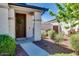 Inviting front entrance with a decorative wreath, lush landscaping, and a walkway at 2185 N Beverly Pl, Buckeye, AZ 85396