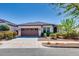 Charming single-story home with a well-maintained front yard, lush landscaping, and a two-car garage at 2185 N Beverly Pl, Buckeye, AZ 85396