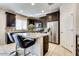 Modern kitchen showcasing granite countertops, stainless steel appliances, and an island with seating at 2185 N Beverly Pl, Buckeye, AZ 85396