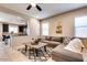 Comfortable living room showcasing an open layout with kitchen access and neutral tones at 2185 N Beverly Pl, Buckeye, AZ 85396