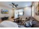 Inviting living room with a large sectional sofa and seamless flow into the kitchen area at 2185 N Beverly Pl, Buckeye, AZ 85396