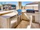 Outdoor kitchen features a stainless steel grill, refrigerator, and counter space, ideal for entertaining at 2185 N Beverly Pl, Buckeye, AZ 85396