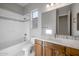 Bright bathroom features tub, toilet, vanity with marble countertop, and natural light from the window at 2887 W Chevelon Dr, Queen Creek, AZ 85144