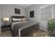 Serene bedroom featuring a bed with a dark headboard and natural lighting from the window at 2887 W Chevelon Dr, Queen Creek, AZ 85144