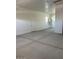 Spacious garage with concrete flooring, white walls, and natural light from the windows at 2887 W Chevelon Dr, Queen Creek, AZ 85144