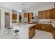 Modern kitchen featuring sleek white quartz countertops, dark wood cabinets, and stainless steel appliances at 2887 W Chevelon Dr, Queen Creek, AZ 85144