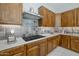 Kitchen with stainless steel range hood, light quartz counters and beautiful light-brown cabinets at 2887 W Chevelon Dr, Queen Creek, AZ 85144