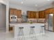 Modern kitchen featuring sleek white quartz countertops, dark wood cabinets, and stainless steel appliances at 2887 W Chevelon Dr, Queen Creek, AZ 85144