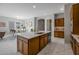 Spacious kitchen with white quartz countertops and dark cabinets is open to the dining area at 2887 W Chevelon Dr, Queen Creek, AZ 85144