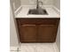 Close-up on bathroom sink with wood cabinets and modern fixtures at 2887 W Chevelon Dr, Queen Creek, AZ 85144