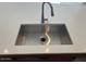 Stainless steel sink with a sleek faucet on a white countertop at 2887 W Chevelon Dr, Queen Creek, AZ 85144