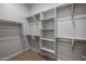 Organized walk-in closet with shelving and hanging rods at 2887 W Chevelon Dr, Queen Creek, AZ 85144