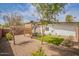 Landscaped backyard with gravel, synthetic grass, and custom wood pergola with seating area at 291 N Washington St, Chandler, AZ 85225