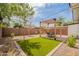 Cozy backyard with a dining table under the pergola and a patch of synthetic grass at 291 N Washington St, Chandler, AZ 85225